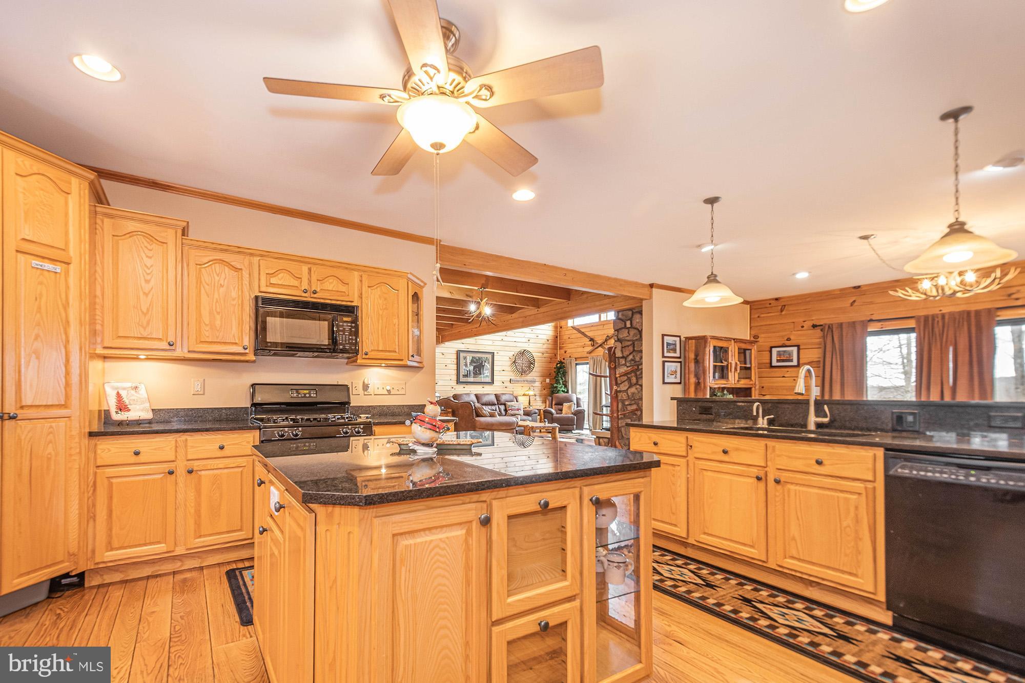 642 Deep Creek Highlands Road McHenry, MD 21541 - Photo 13 of 59 a kitchen with stainless steel appliances kitchen island granite countertop a sink and cabinets