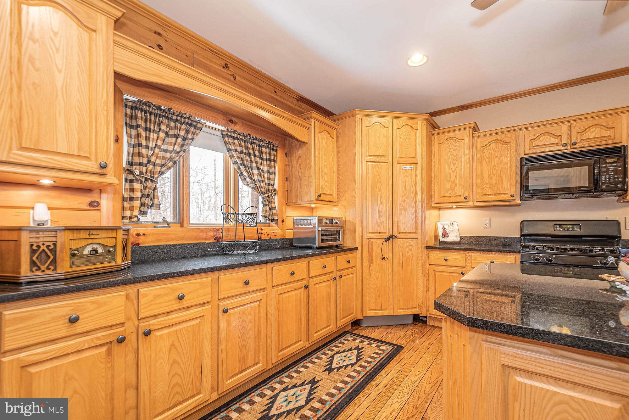 642 Deep Creek Highlands Road McHenry, MD 21541 - Photo 14 of 59 a kitchen with stainless steel appliances granite countertop a stove sink and cabinets