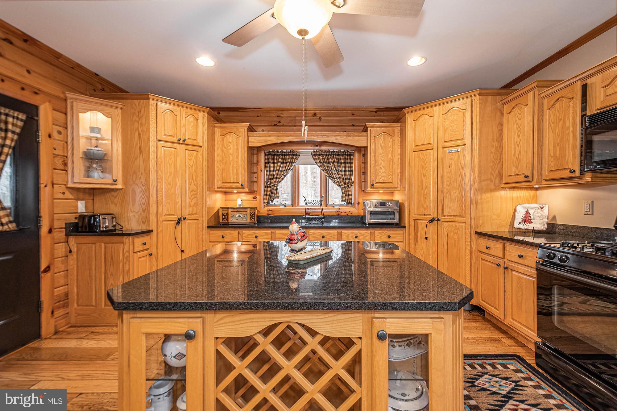 642 Deep Creek Highlands Road McHenry, MD 21541 - Photo 17 of 59 a kitchen with stainless steel appliances granite countertop a stove a sink and a refrigerator