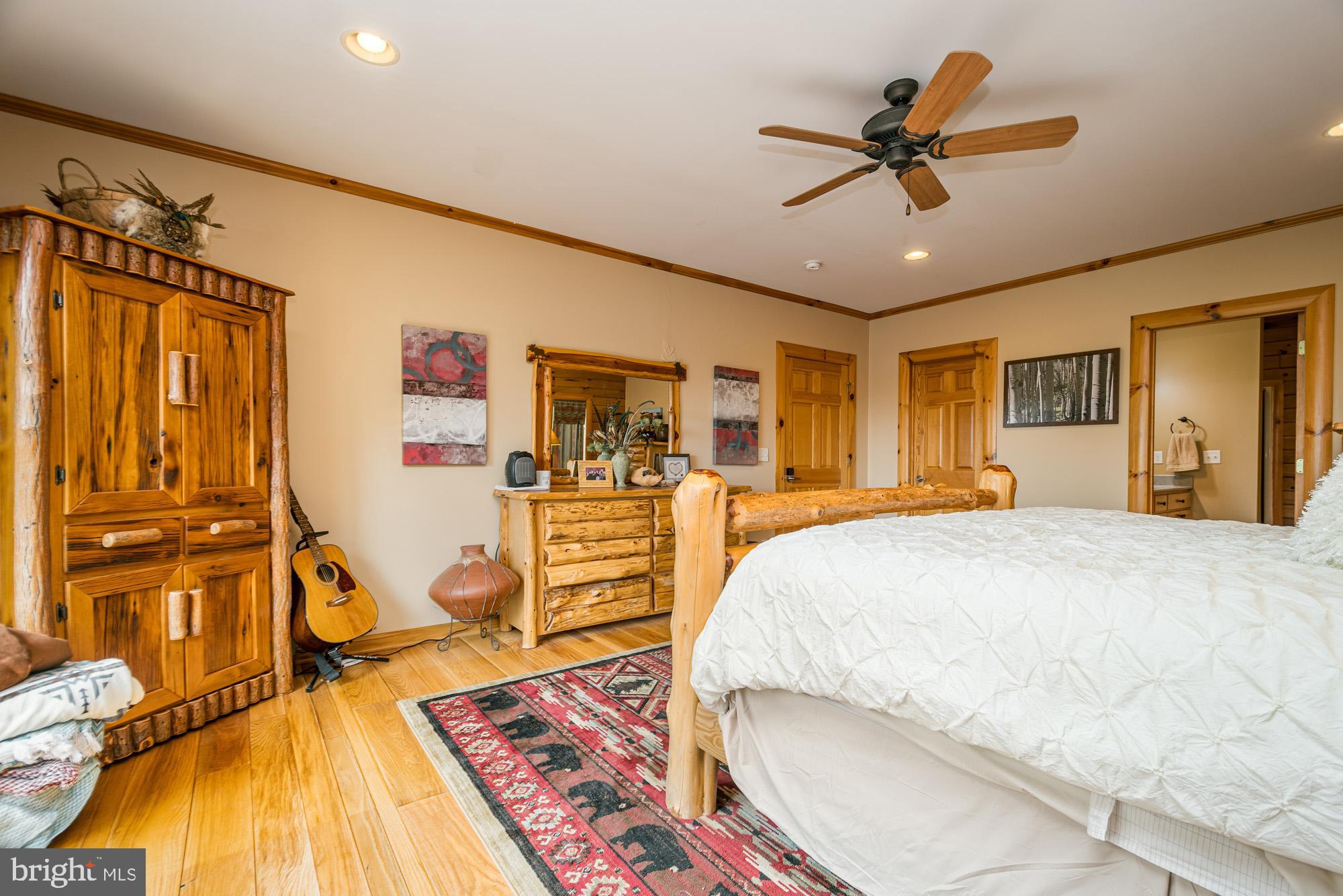 642 Deep Creek Highlands Road McHenry, MD 21541 - Photo 20 of 59 a bed room with a bed and a ceiling fan