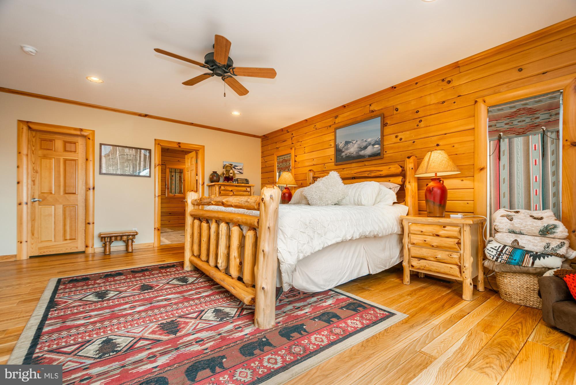 642 Deep Creek Highlands Road McHenry, MD 21541 - Photo 21 of 59 a bedroom with a bed and wooden floor