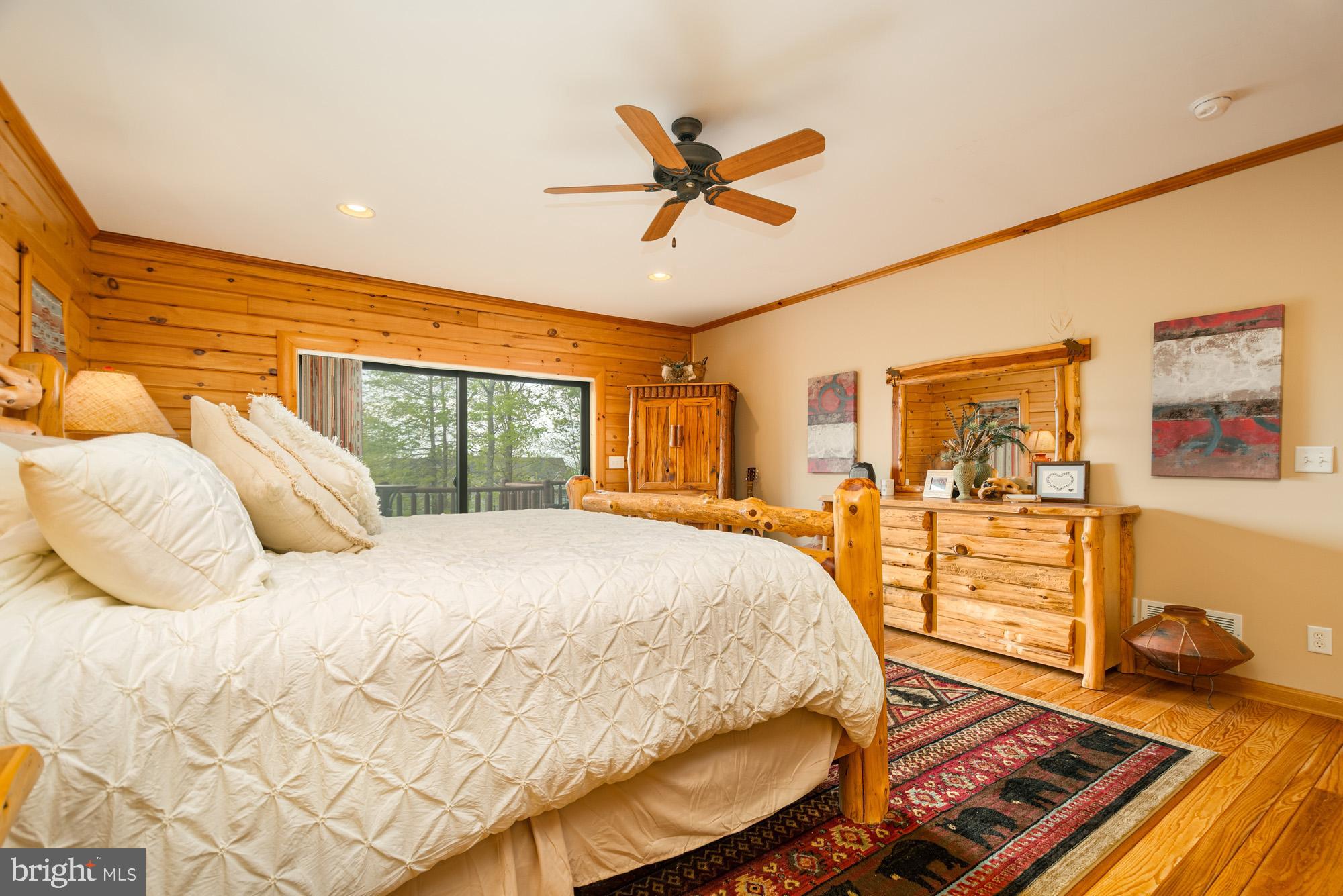 642 Deep Creek Highlands Road McHenry, MD 21541 - Photo 22 of 59 a bedroom with a bed and wooden floor