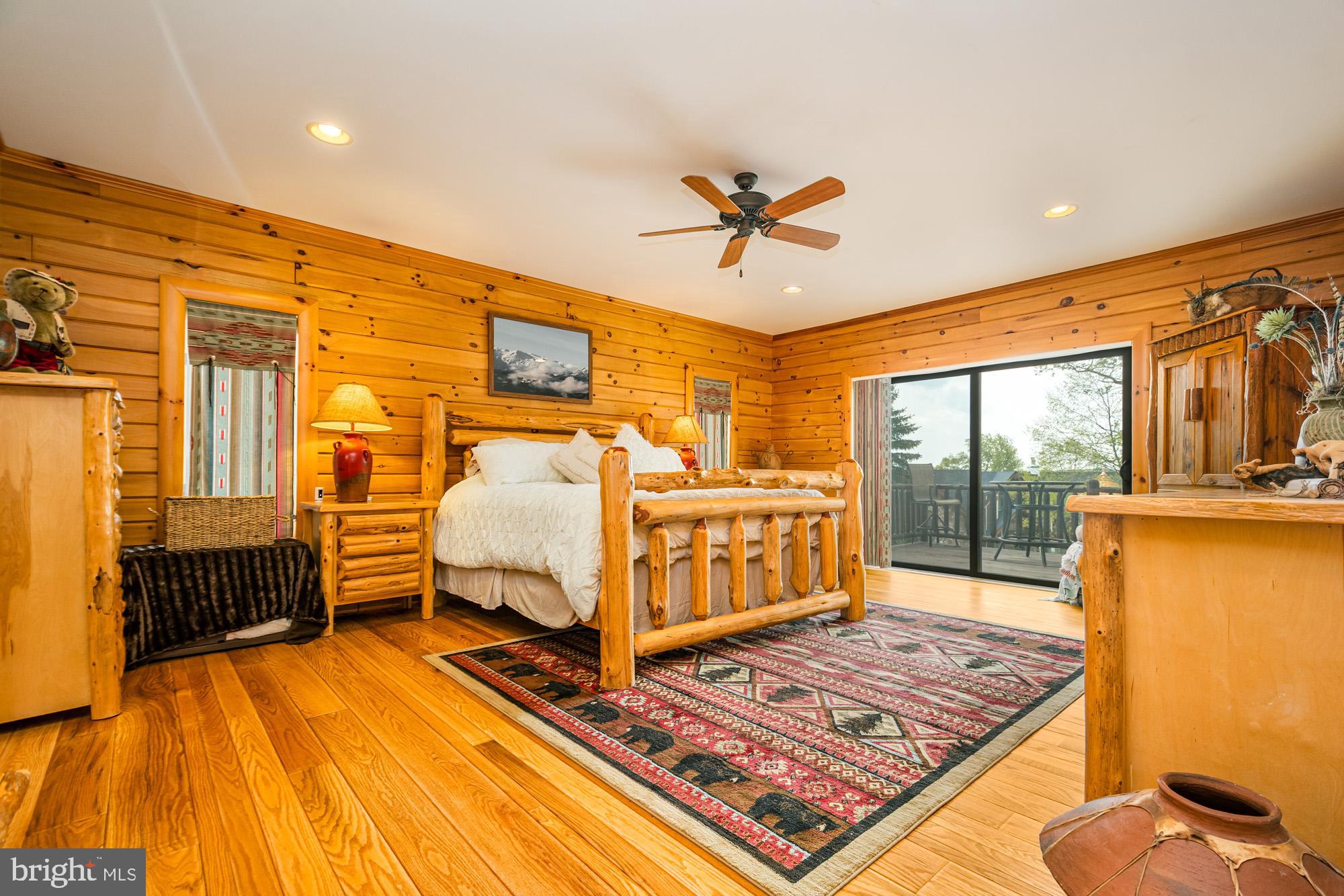 642 Deep Creek Highlands Road McHenry, MD 21541 - Photo 23 of 59 a bedroom with a bed and wooden floor