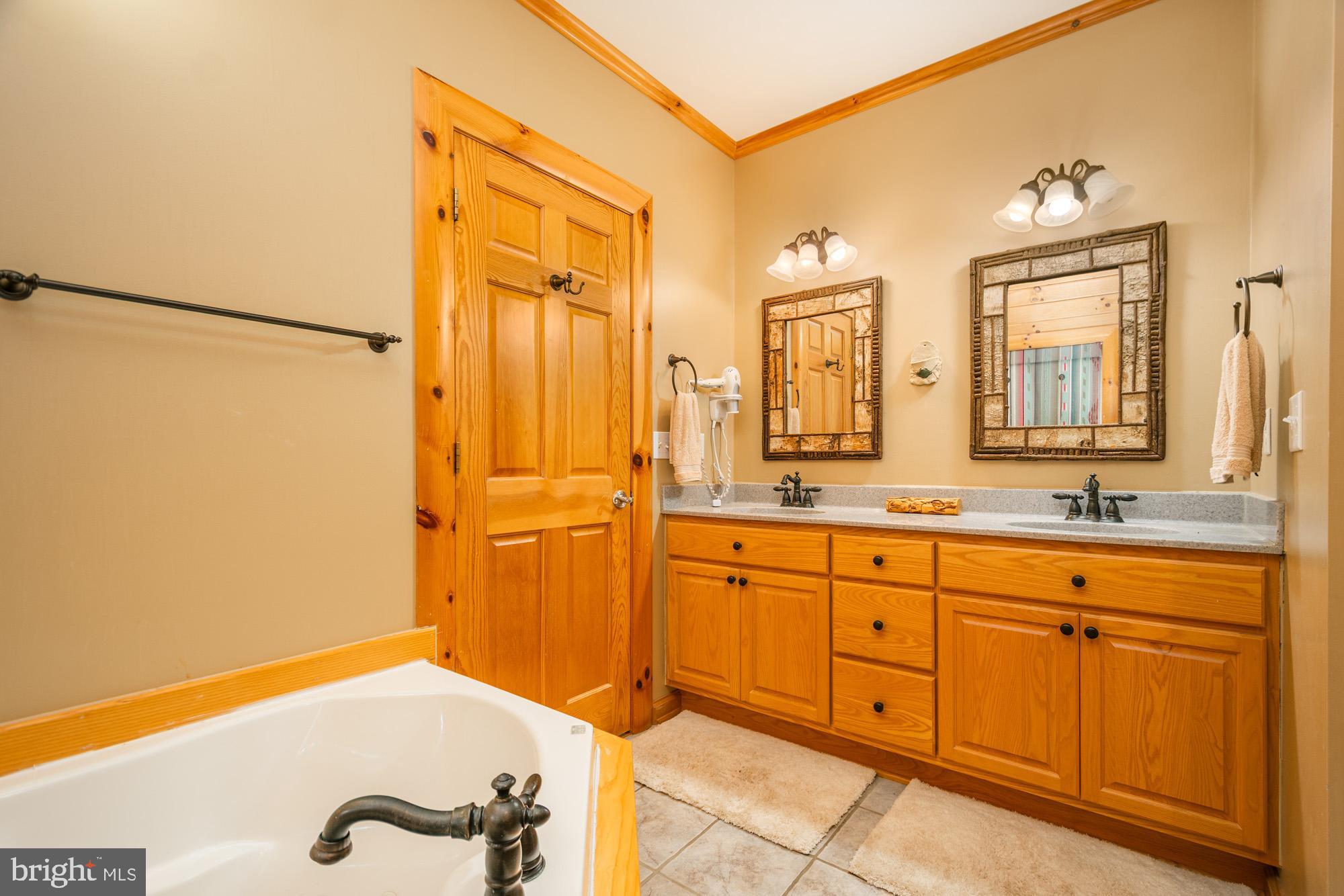 642 Deep Creek Highlands Road McHenry, MD 21541 - Photo 25 of 59 a bathroom with a sink and a mirror