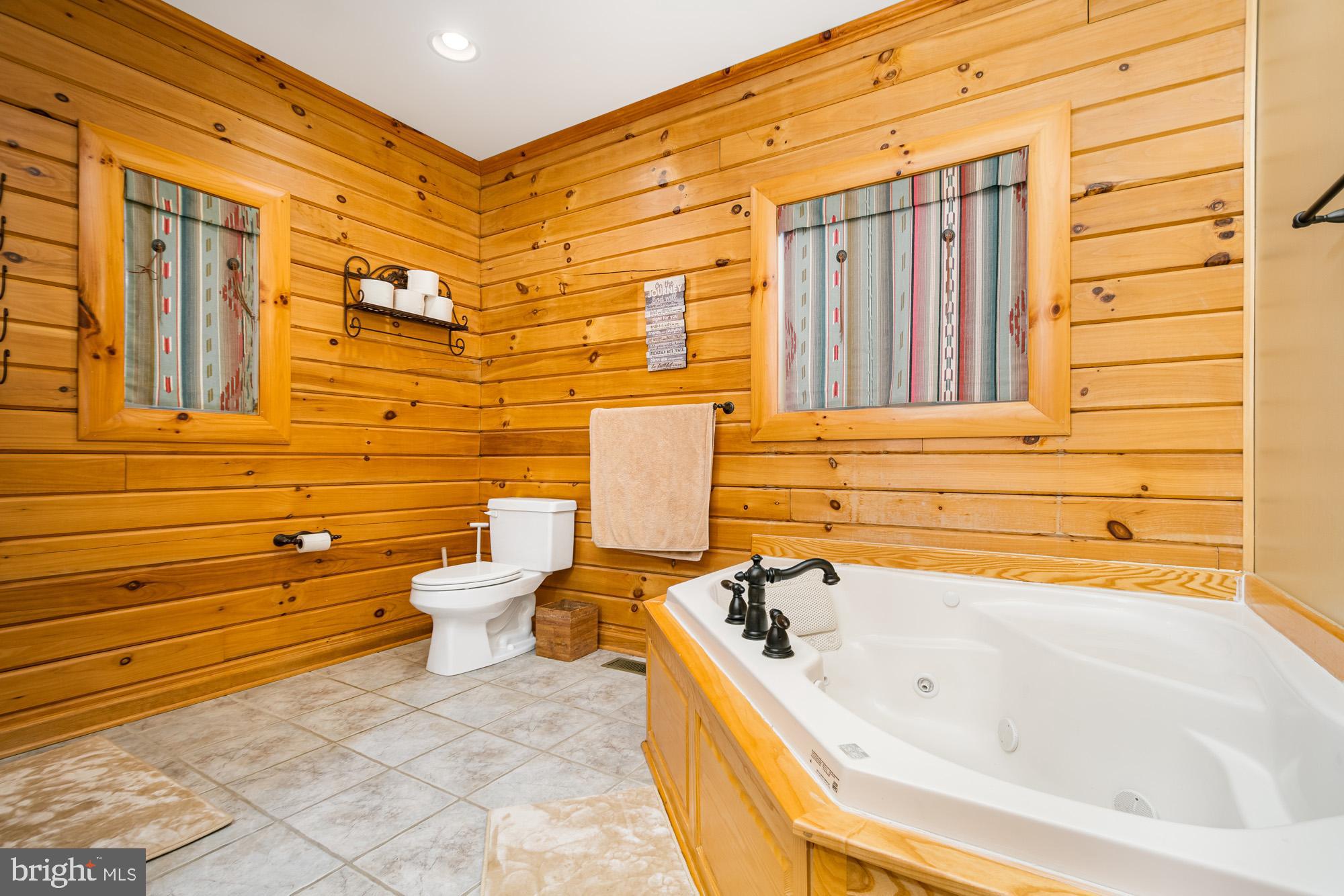 642 Deep Creek Highlands Road McHenry, MD 21541 - Photo 26 of 59 a bathroom with a bathtub and shower