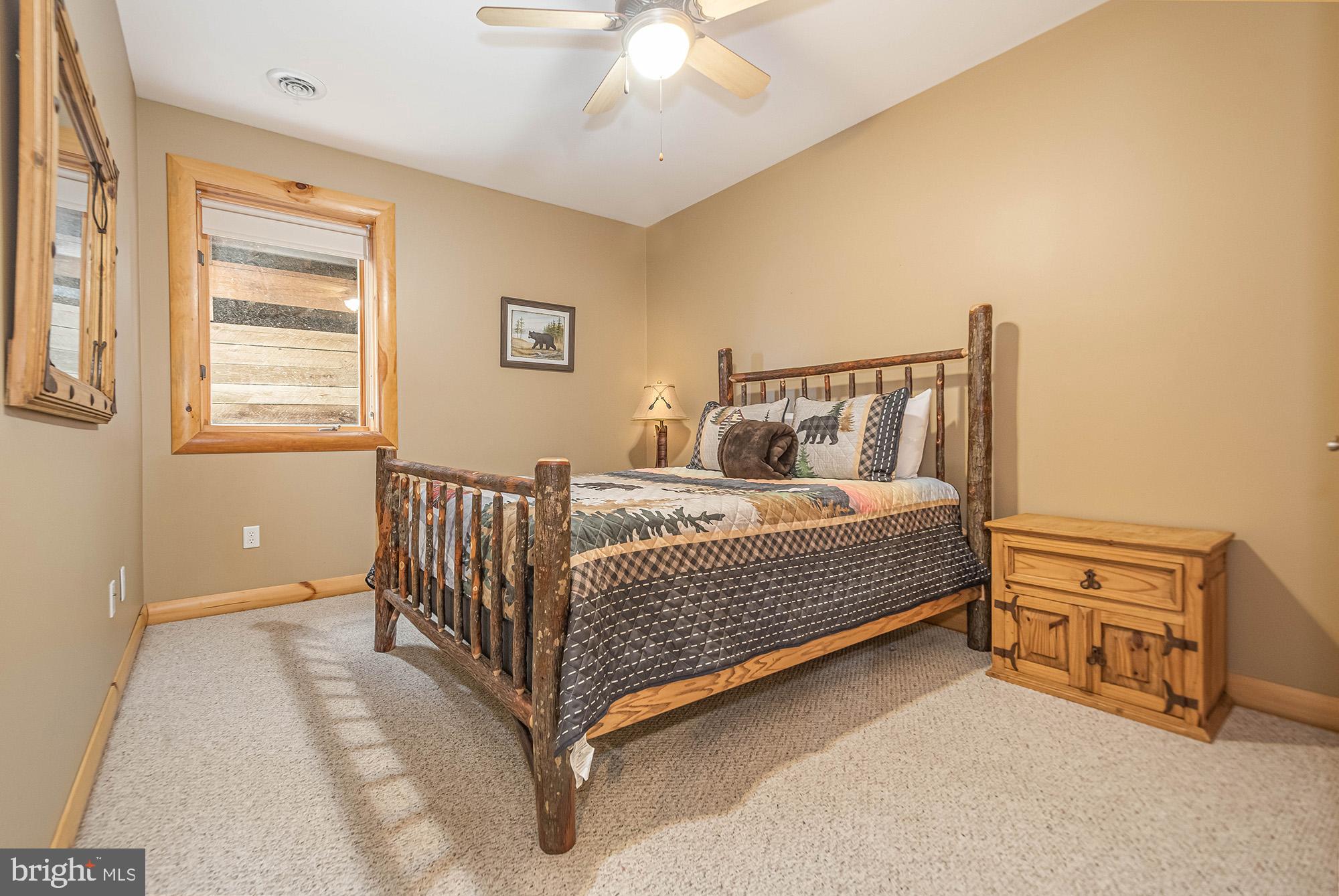 642 Deep Creek Highlands Road McHenry, MD 21541 - Photo 30 of 59 a bed sitting in a bedroom next to a window