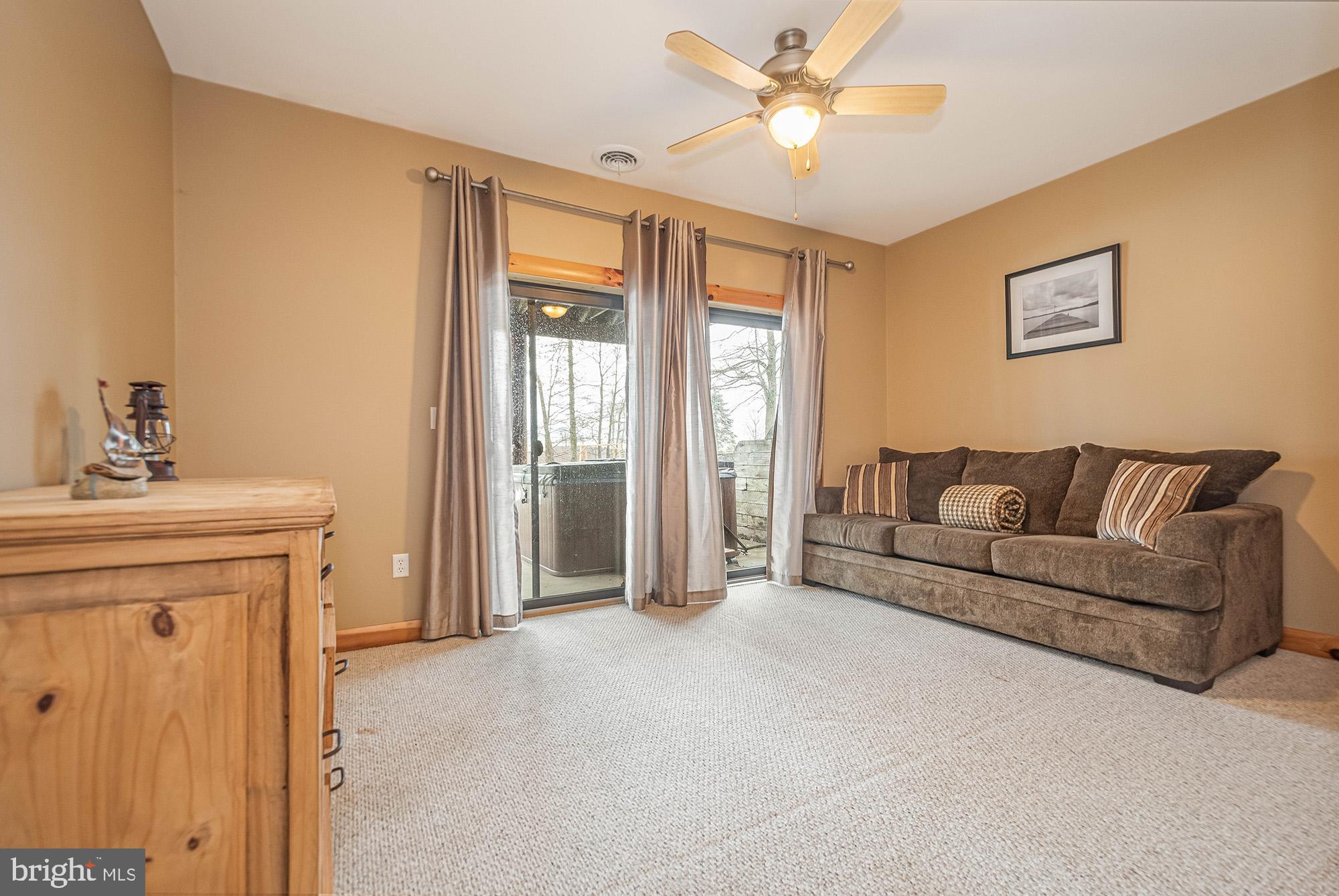642 Deep Creek Highlands Road McHenry, MD 21541 - Photo 31 of 59 a living room with furniture and a chandelier
