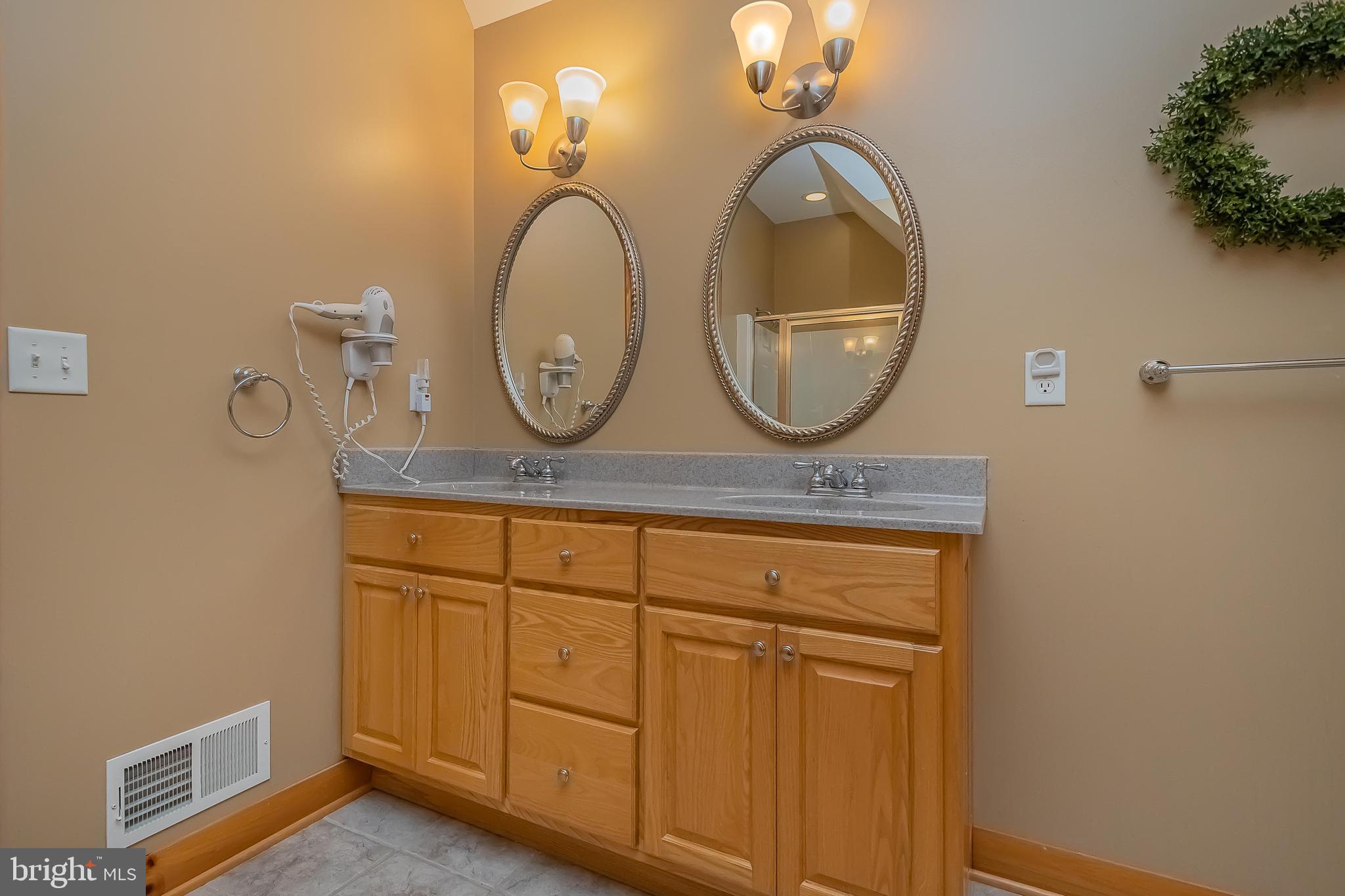 642 Deep Creek Highlands Road McHenry, MD 21541 - Photo 40 of 59 a bathroom with a sink and a mirror