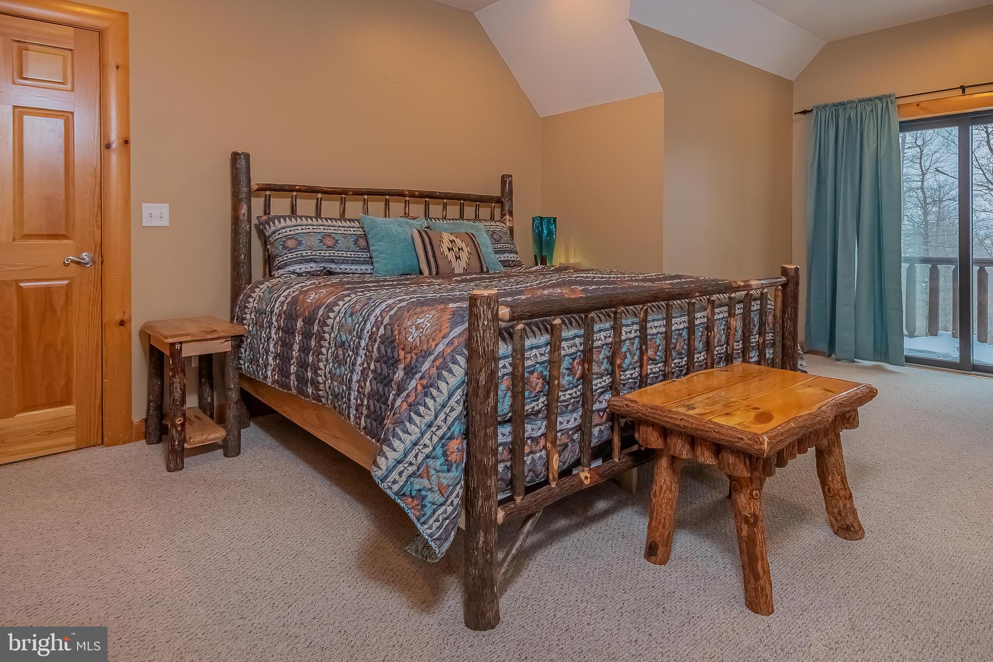 642 Deep Creek Highlands Road McHenry, MD 21541 - Photo 42 of 59 a bedroom with a bed and window