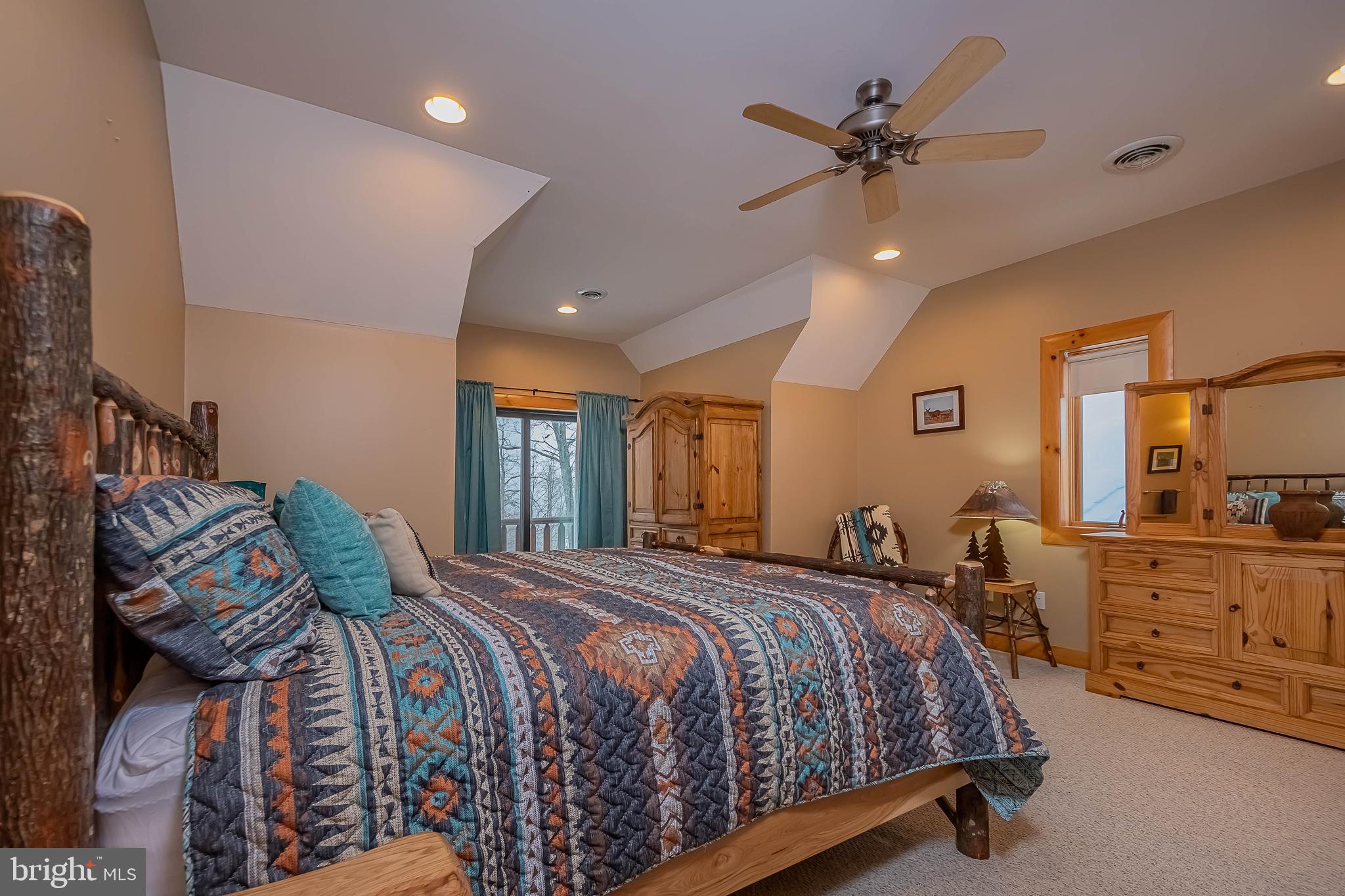 642 Deep Creek Highlands Road McHenry, MD 21541 - Photo 44 of 59 a bedroom with a bed a window and dresser