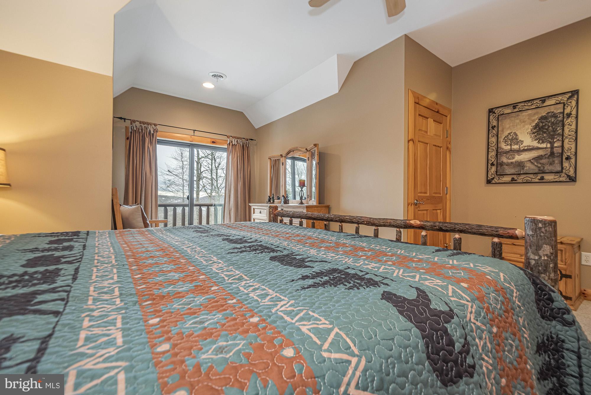 642 Deep Creek Highlands Road McHenry, MD 21541 - Photo 45 of 59 a bedroom with a bed and a window