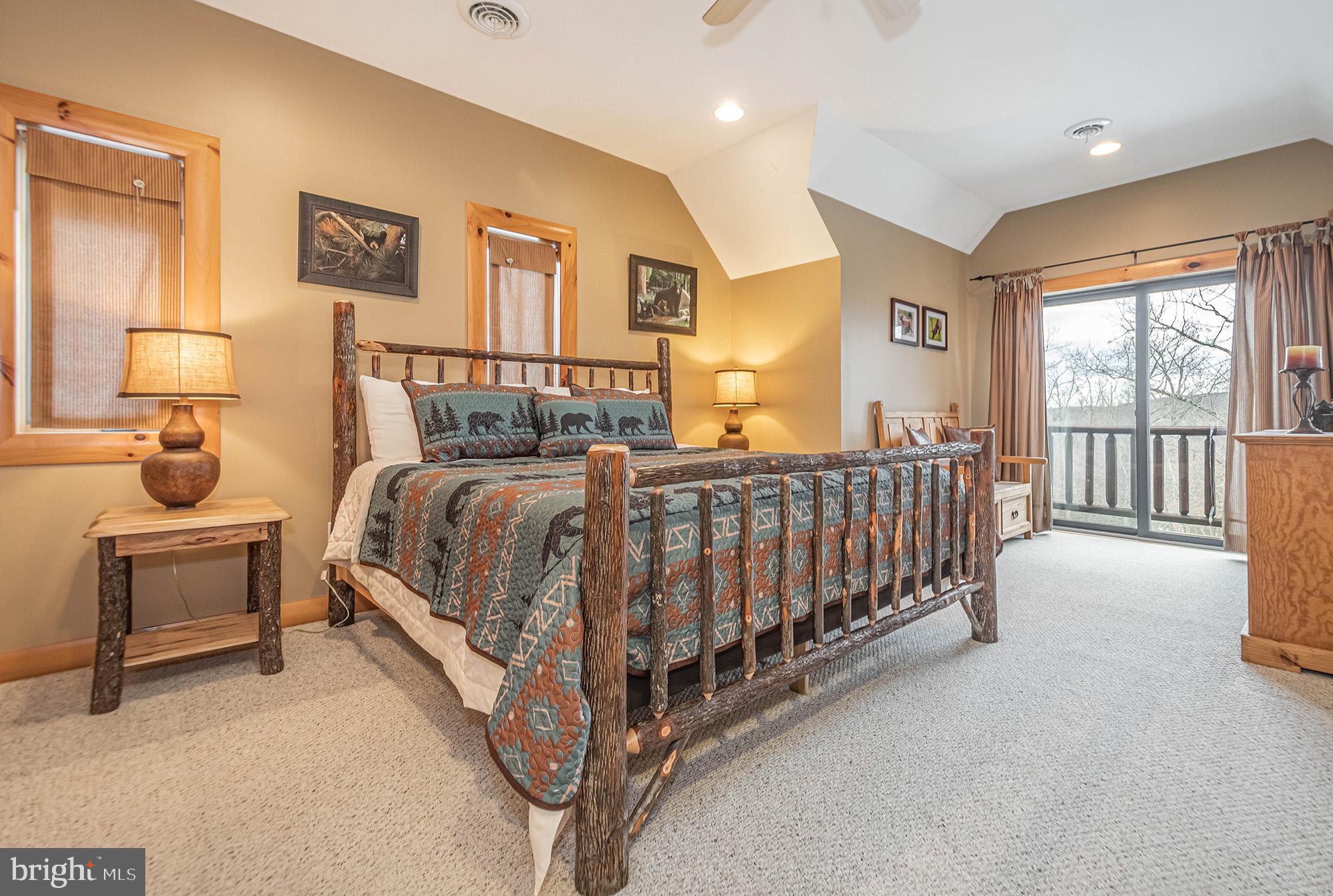 642 Deep Creek Highlands Road McHenry, MD 21541 - Photo 46 of 59 a bedroom with a bed and a large window