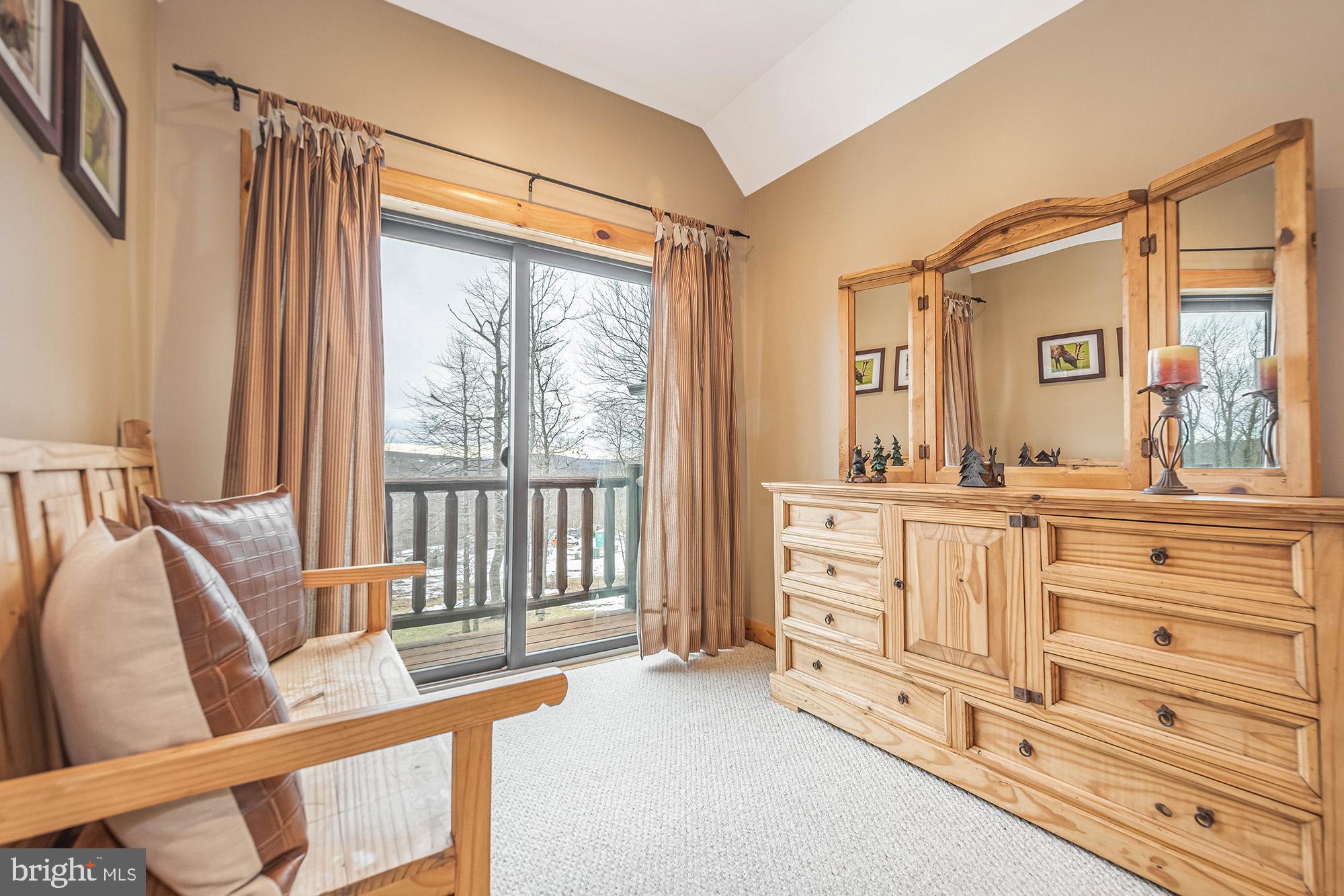 642 Deep Creek Highlands Road McHenry, MD 21541 - Photo 47 of 59 a spacious bathroom with a double vanity sink and a large mirror