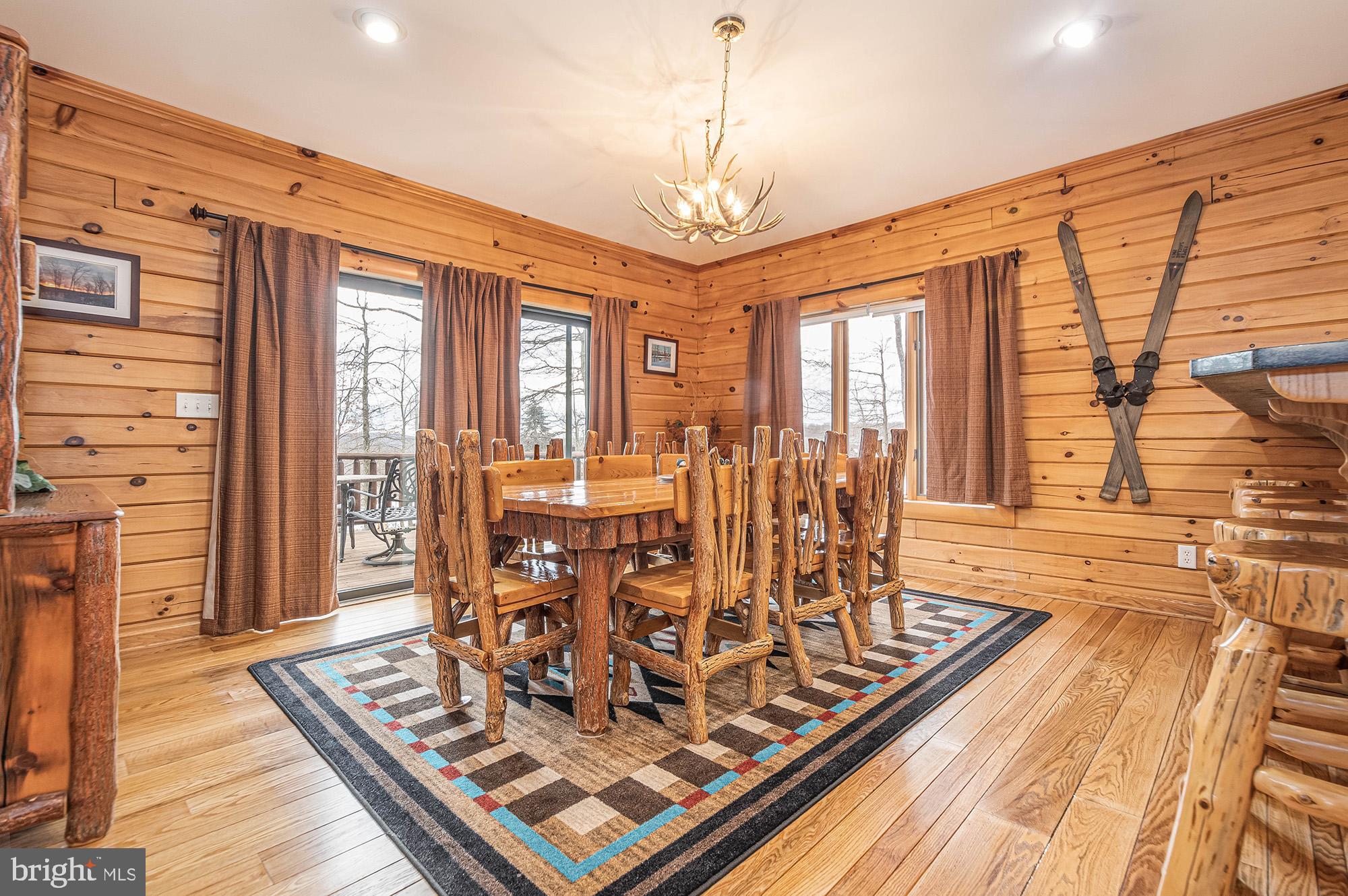 642 Deep Creek Highlands Road McHenry, MD 21541 - Photo 5 of 59 a view of a dining room with furniture window and wooden floor