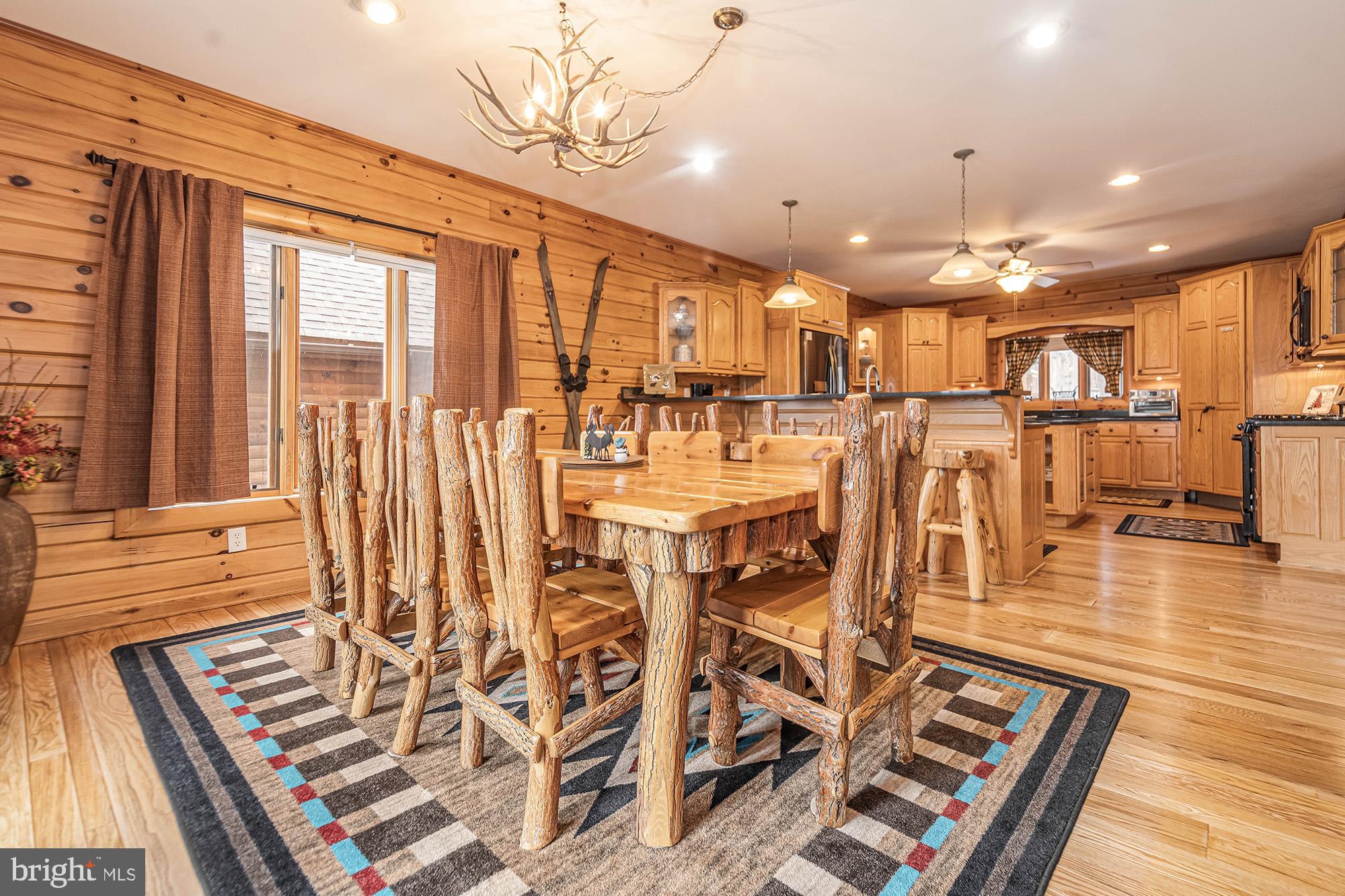 642 Deep Creek Highlands Road McHenry, MD 21541 - Photo 6 of 59 a view of a patio with dining table and chairs