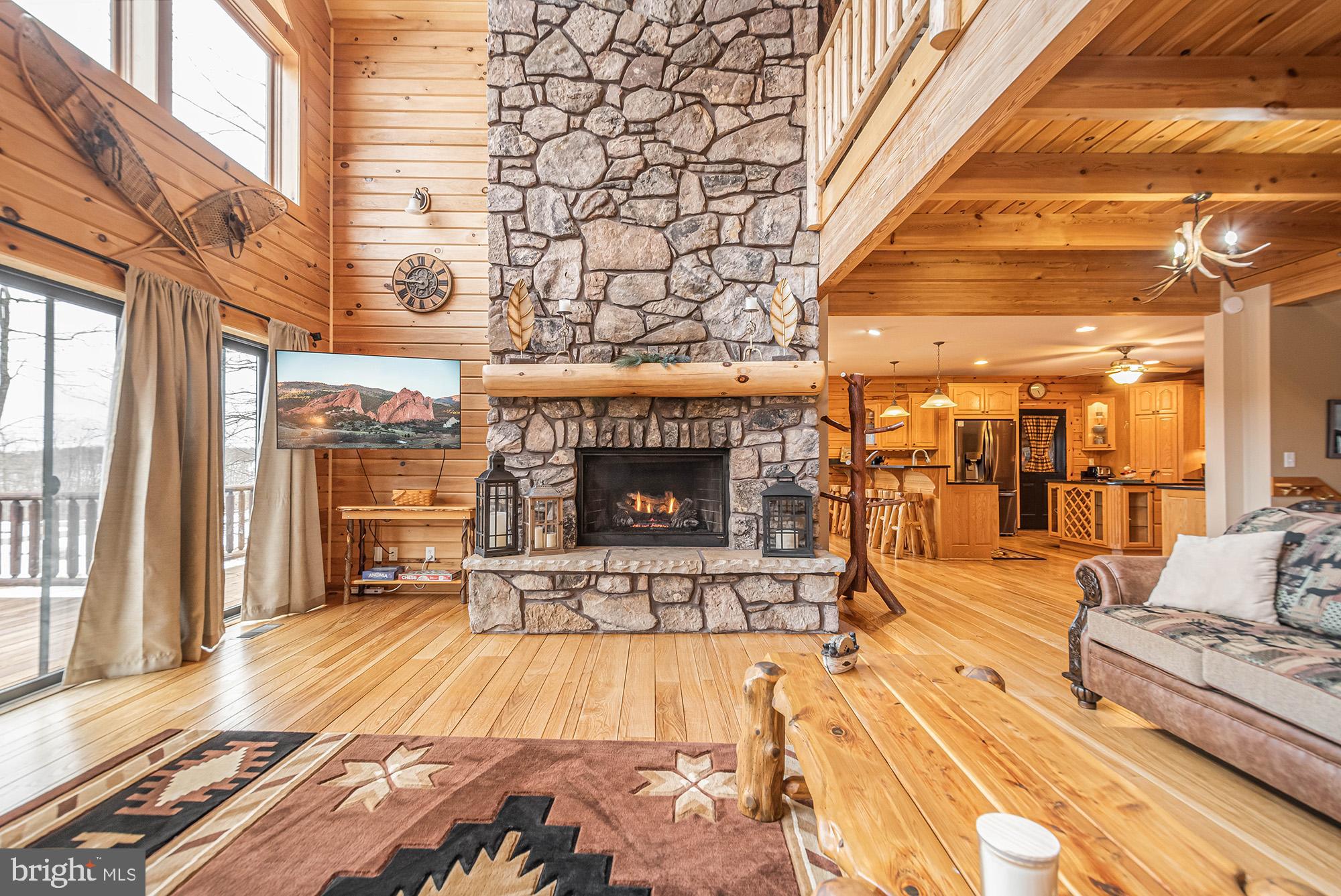 642 Deep Creek Highlands Road McHenry, MD 21541 - Photo 10 of 59 a view of a patio with a table and chairs next to a large window
