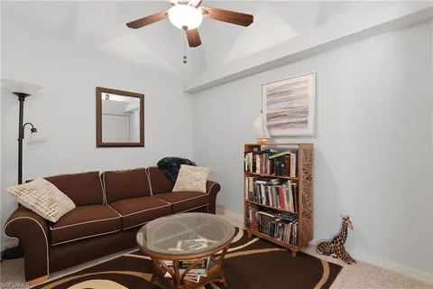 a living room with furniture a rug and a window
