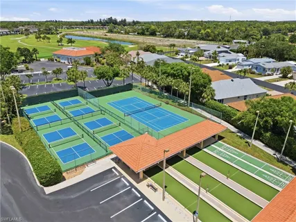 an aerial view of a tennis ground and a lake view