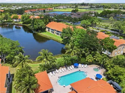 an aerial view of lake and residential houses with outdoor space