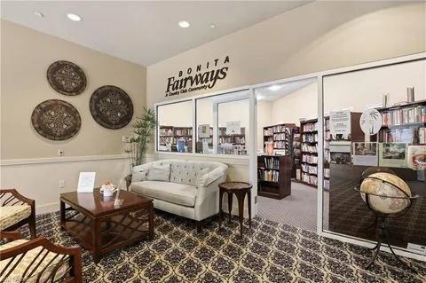 a living room with furniture a clock and a table
