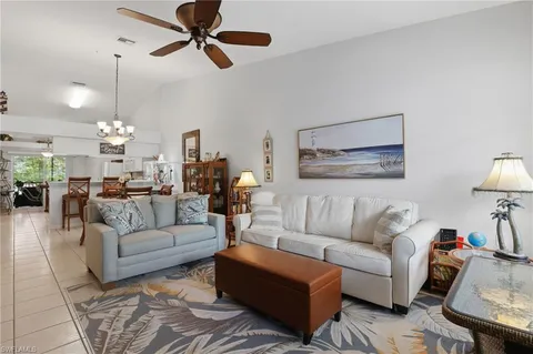 a living room with furniture chandelier and a chandelier