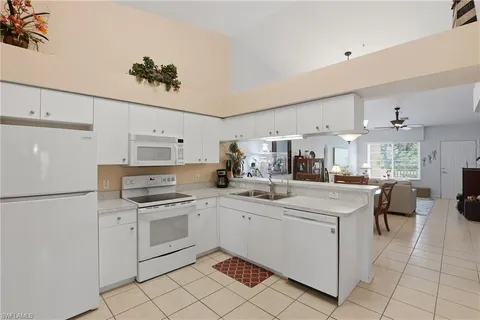 a kitchen with a sink appliances and cabinets