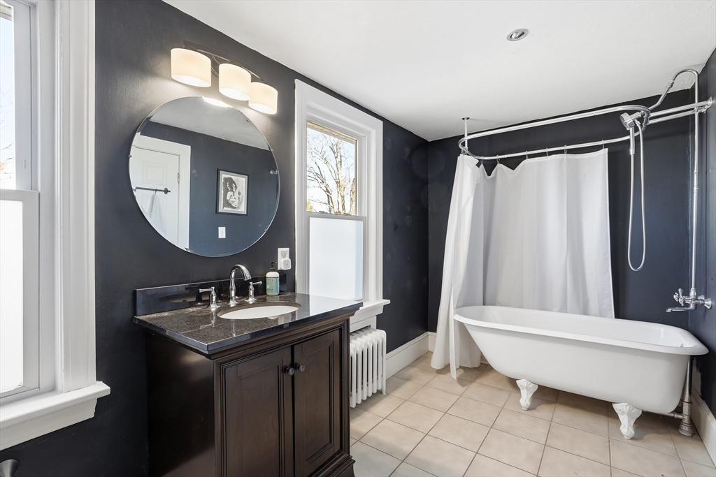 23 A Street Hull, MA 02045 - Photo 14 of 42 a bathroom with a sink toilet and a mirror