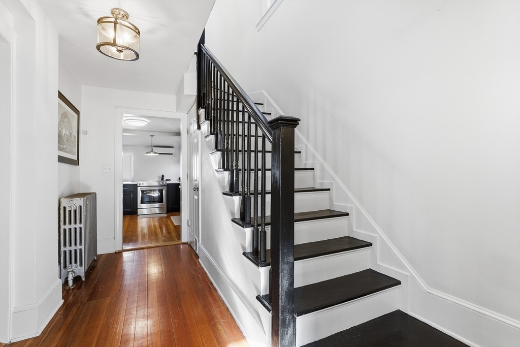 23 A Street Hull, MA 02045 - Photo 15 of 42 a view of a hallway with wooden floor and staircase