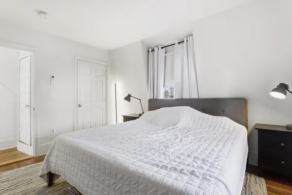 a bedroom with a bed and a potted plant