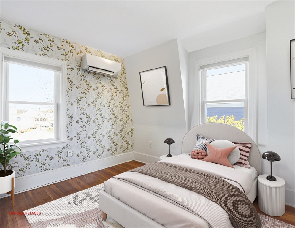 23 A Street Hull, MA 02045 - Photo 18 of 42 a bedroom with a bed and a window with painted walls