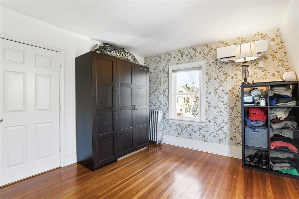 23 A Street Hull, MA 02045 - Photo 20 of 42 an empty room with wooden floor and windows