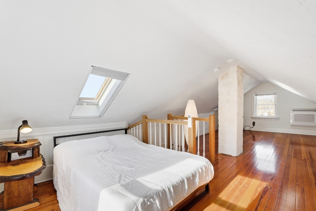 23 A Street Hull, MA 02045 - Photo 25 of 42 a bedroom with a bed and wooden floor