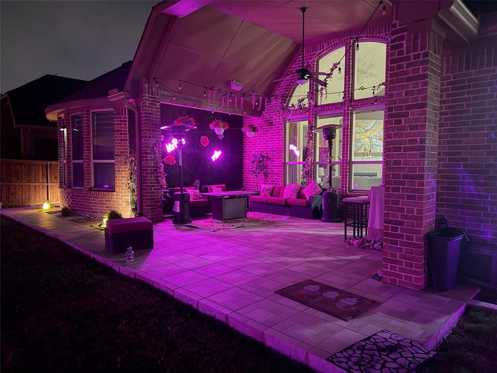 8268 Kara Creek Road Frisco, TX 75036 - Photo 29 of 31 Expansive outdoor patio featuring brick construction, a covered ceiling with a fan, large windows, and a paver stone surface