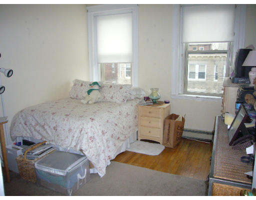 9 Colborne Road, Unit 18 Boston, MA 02135 - Photo 2 of 7 a bedroom with a bed and a window