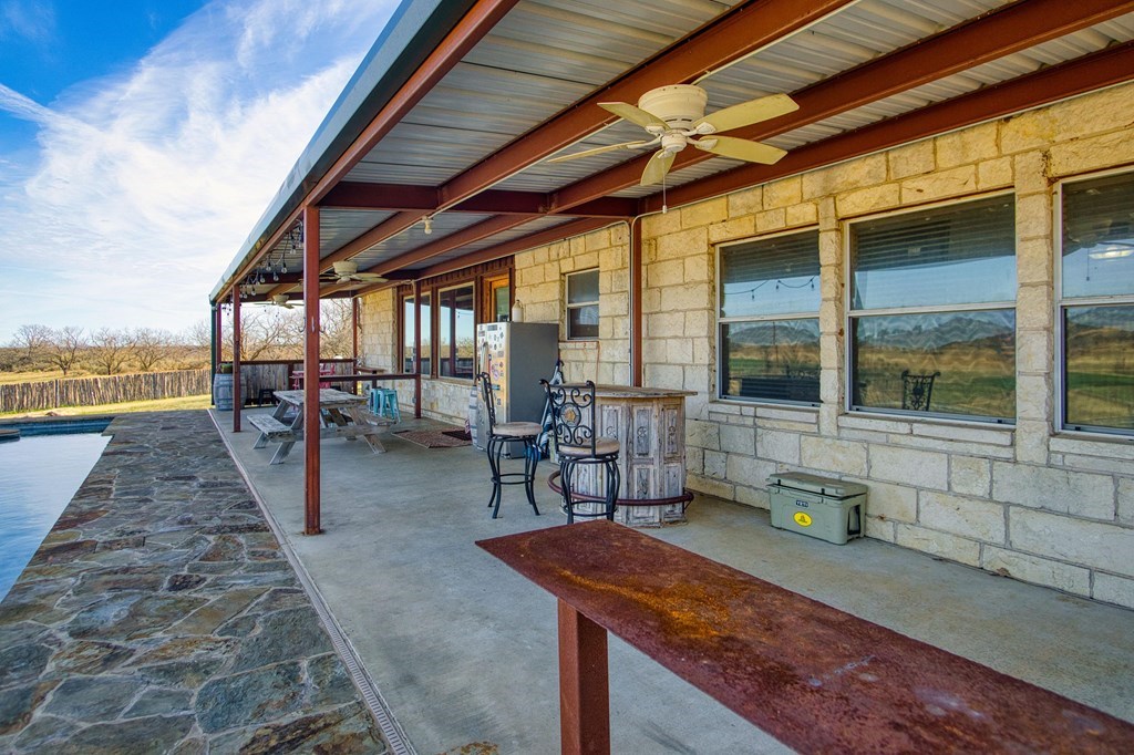 6446 Blackjack Road Fredonia, TX 76842 - Photo 39 of 48 a view of a patio with table and chairs with wooden floor and fence