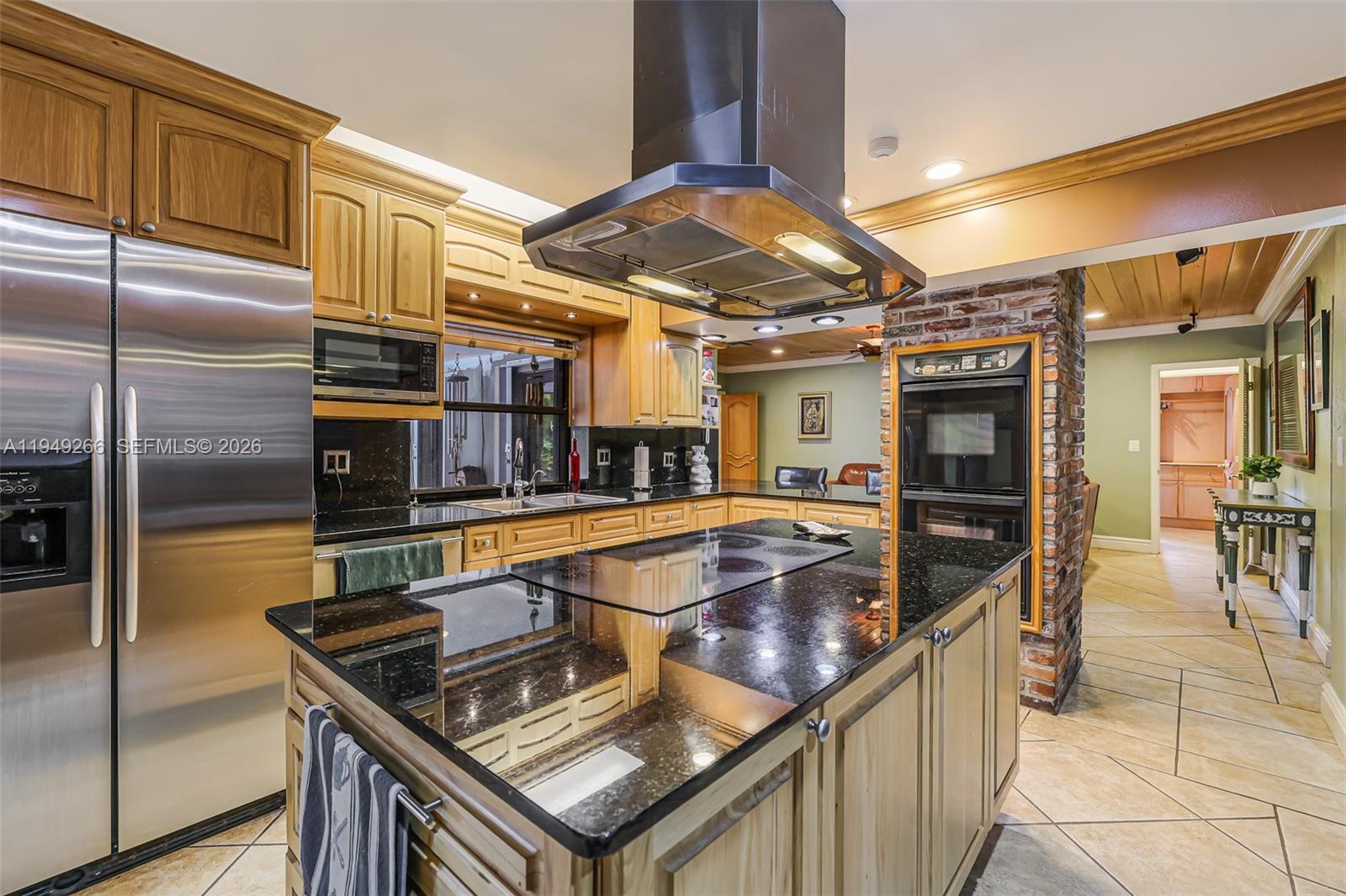 18975 Southwest 224th Street Miami, FL 33170 - Photo 28 of 97 a kitchen with stainless steel appliances granite countertop a sink and a refrigerator