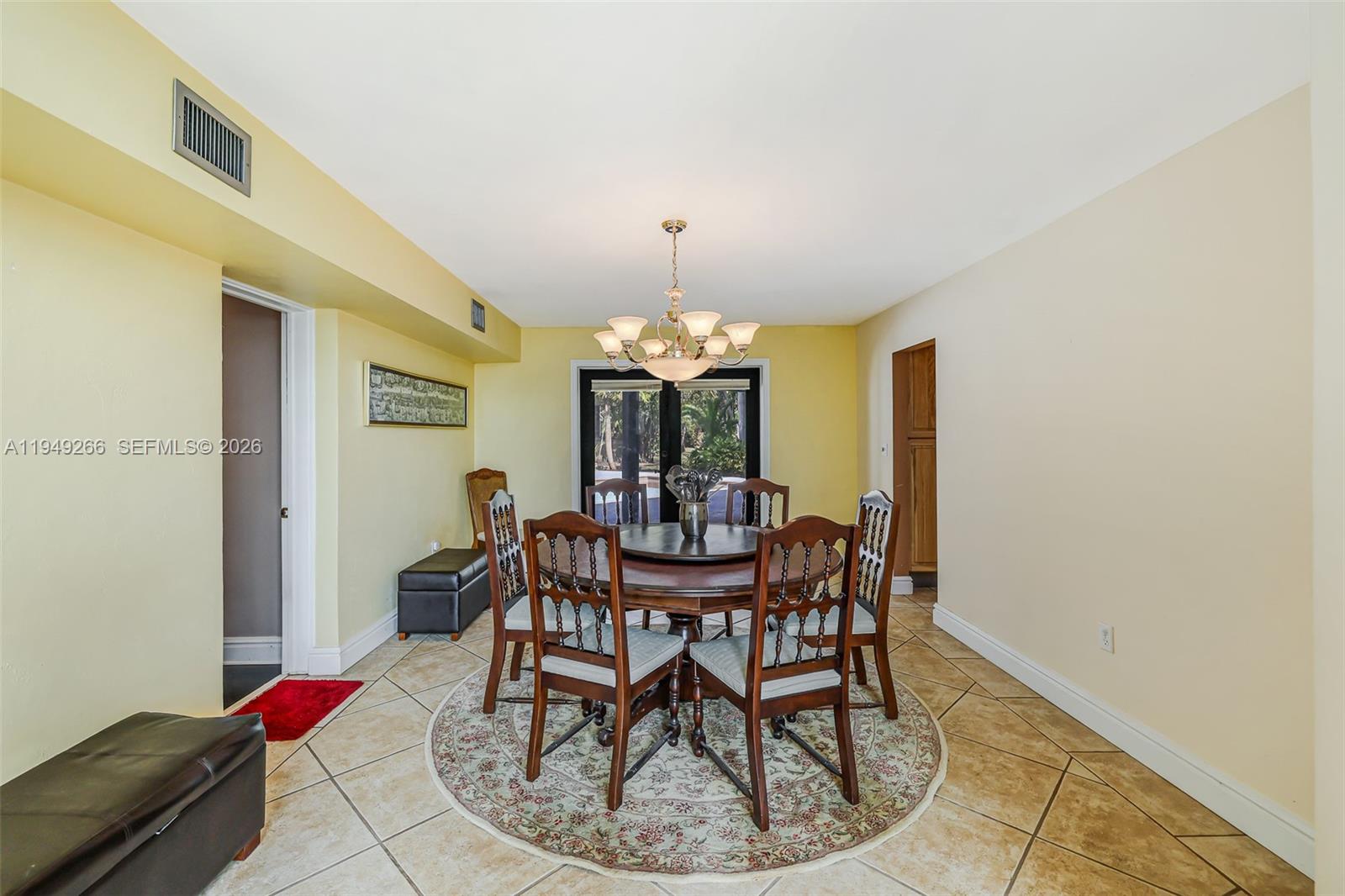18975 Southwest 224th Street Miami, FL 33170 - Photo 34 of 97 a view of a dining room with furniture and chandelier