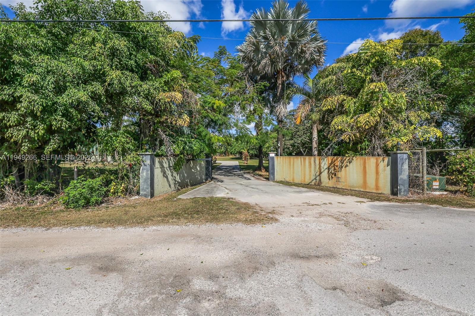 18975 Southwest 224th Street Miami, FL 33170 - Photo 4 of 97 a view of a yard with plants and trees beside of it