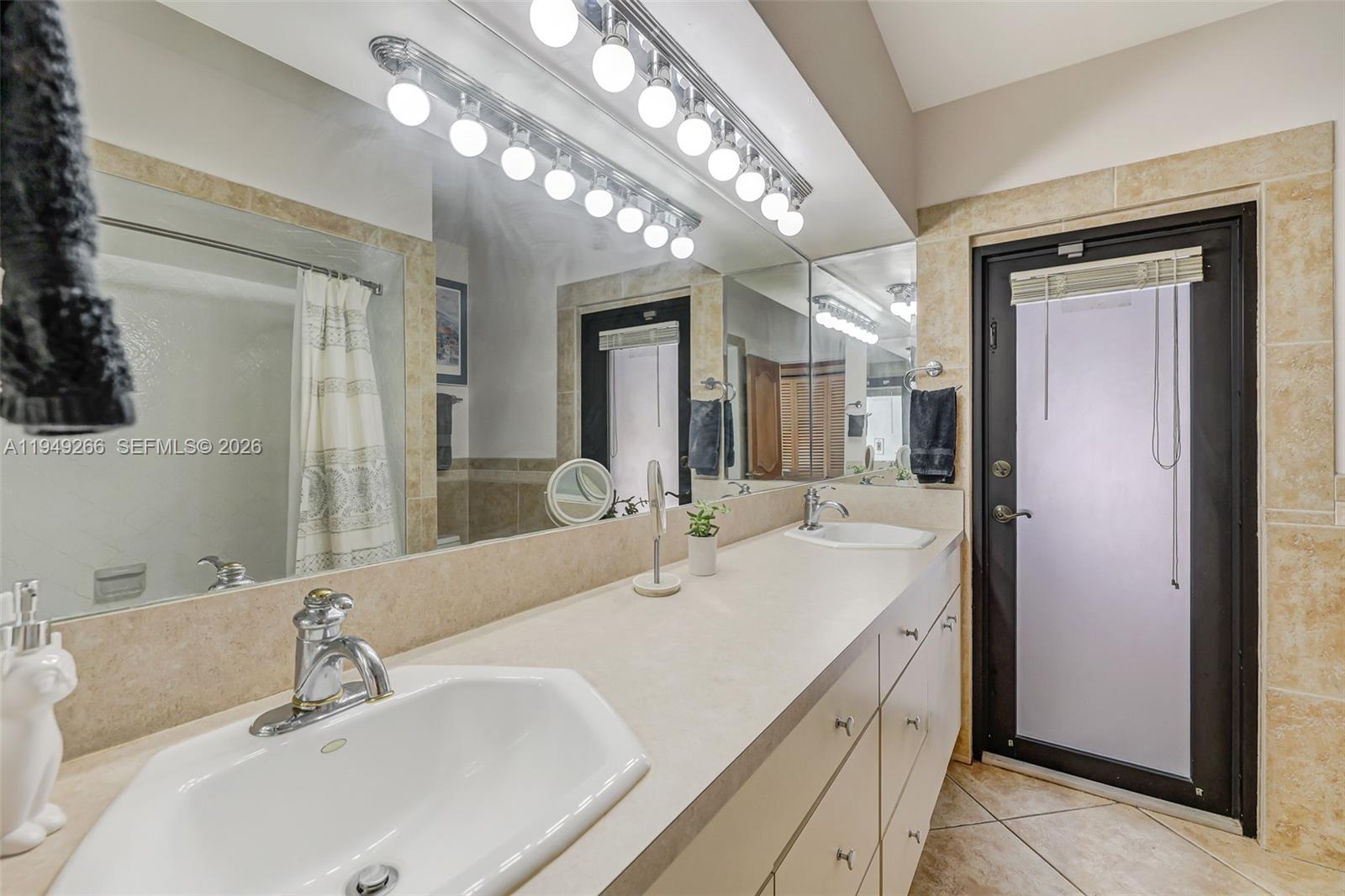 18975 Southwest 224th Street Miami, FL 33170 - Photo 49 of 97 a bathroom with a double vanity sink and a mirror