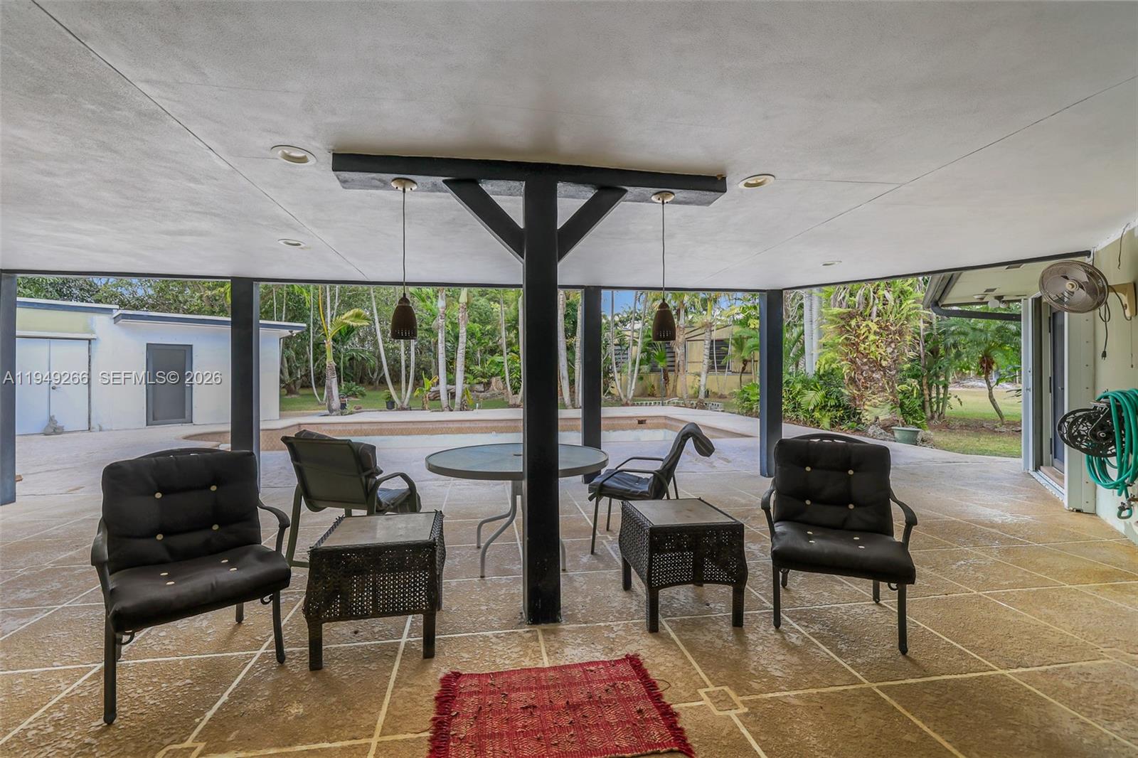 18975 Southwest 224th Street Miami, FL 33170 - Photo 56 of 97 a living room with furniture and a floor to ceiling window