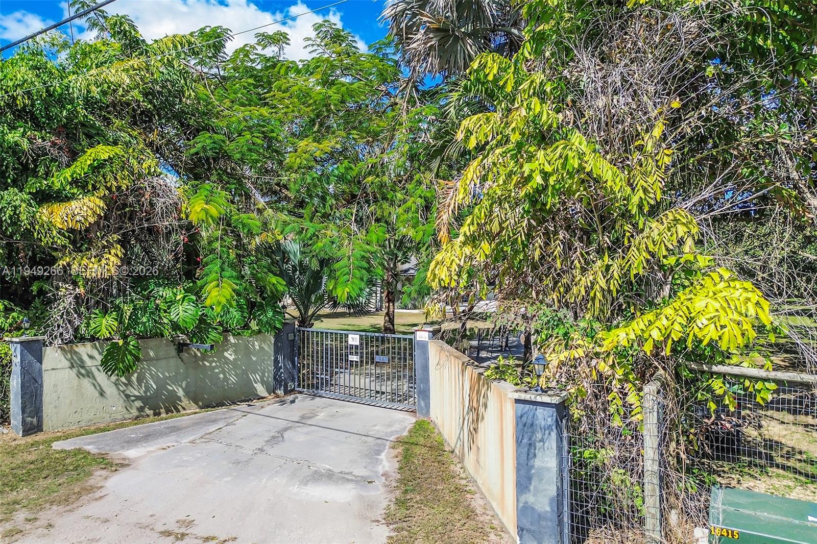 18975 Southwest 224th Street Miami, FL 33170 - Photo 79 of 97 a pathway of a house with a yard