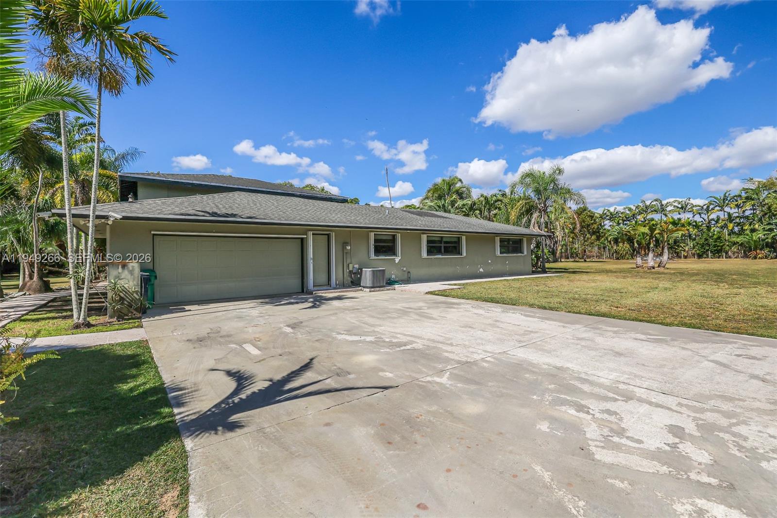 18975 Southwest 224th Street Miami, FL 33170 - Photo 8 of 97 a view of a house with a patio and a yard