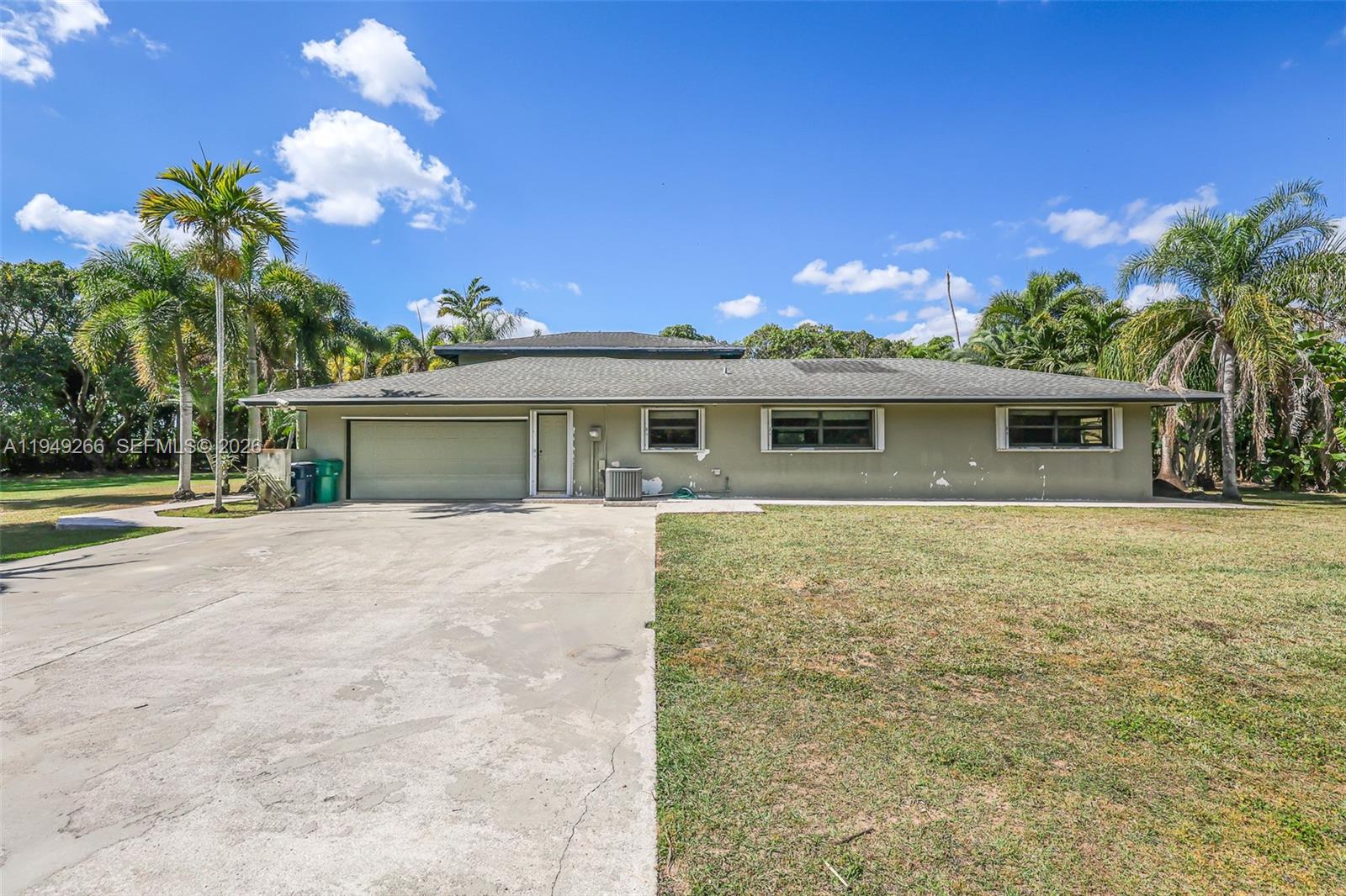 18975 Southwest 224th Street Miami, FL 33170 - Photo 9 of 97 a view of a house with a yard and potted plants