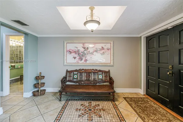 a row of palm trees and a yard with wooden fence