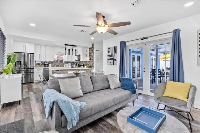 a living room with furniture and kitchen view
