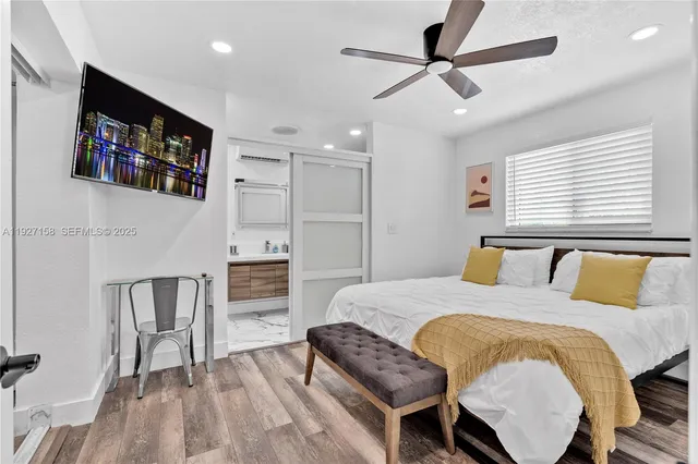 a bedroom with a bed and a flat screen tv