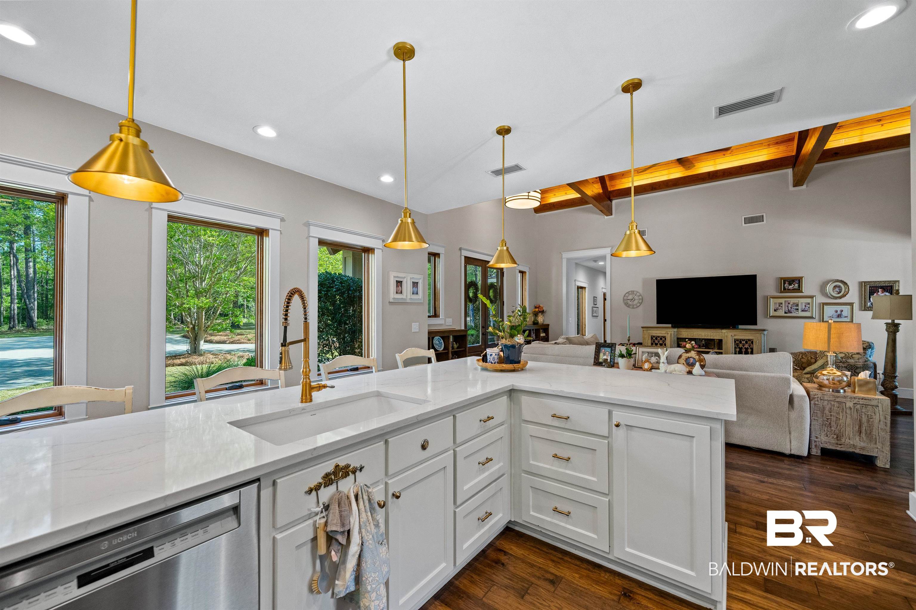47252 Emmons Road Bay Minette, AL 36507 - Photo 50 of 50 Kitchen with light stone countertops, stainless steel dishwasher, open floor plan, dark wood-style floors, and white cabinets