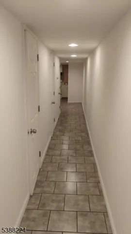 a view of a room with white tiles