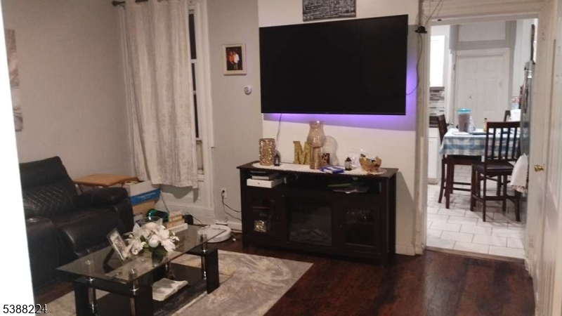 249 Summer Avenue Newark, NJ 07104 - Photo 2 of 16 a living room with furniture and a flat screen tv