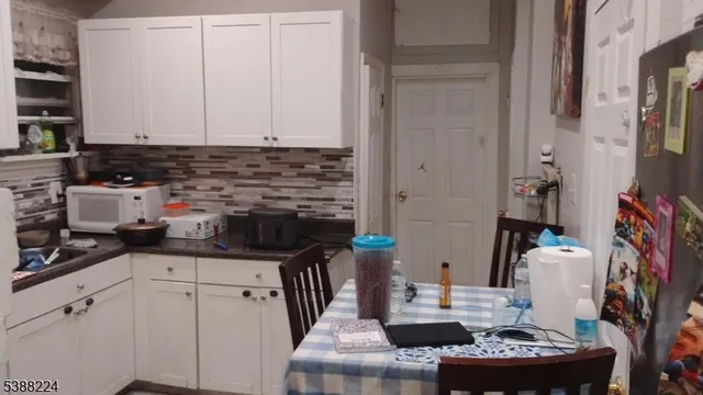 a kitchen with stainless steel appliances kitchen island granite countertop a sink stove and cabinets